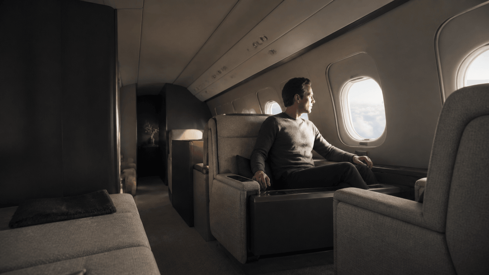 A passenger in the cabin of a private jet in flight